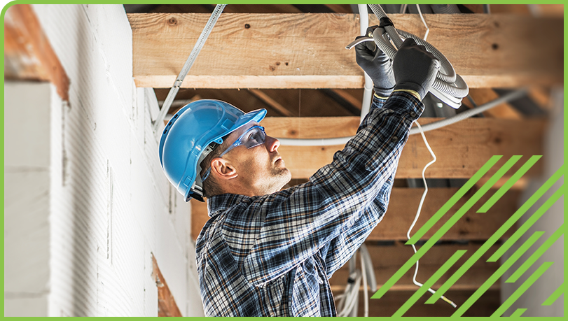 Worker installing electrical on new build